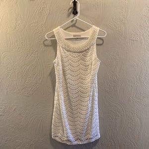 Sleeveless, cream lace dress with beaded neckline